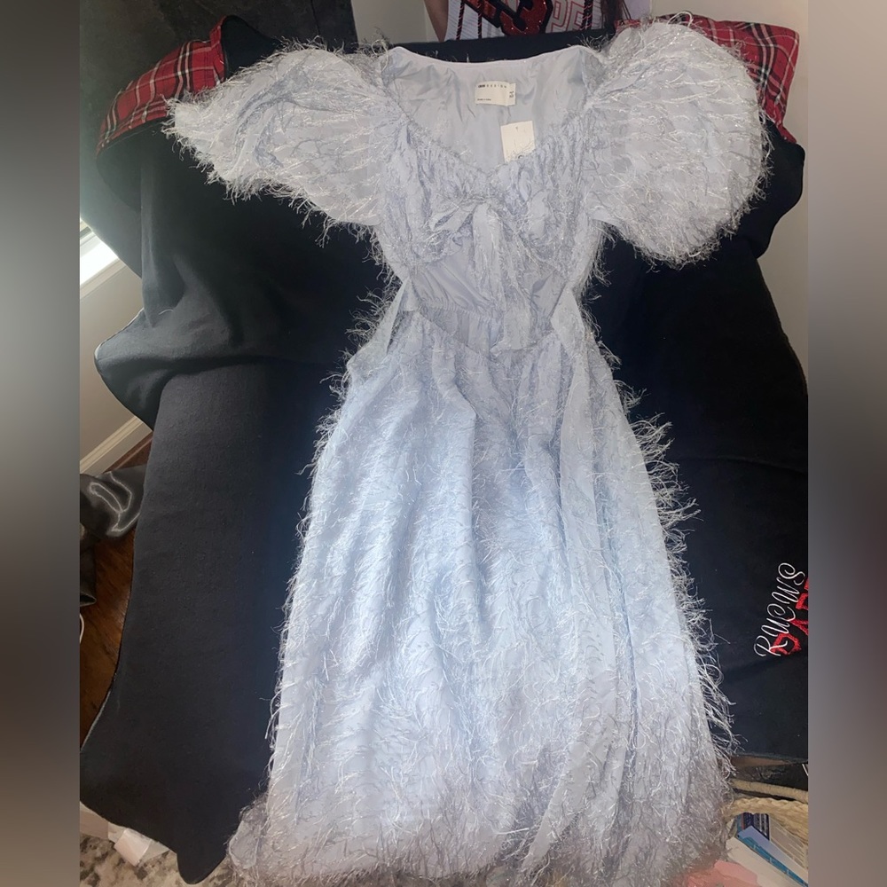 Feathery blue maxi dress with long puffy sleeves and ties in the front
